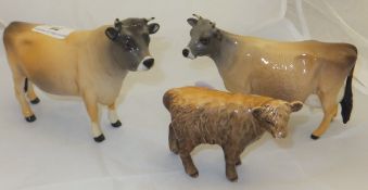 A Beswick pottery bull "Champion Dunsley Coy Boy", a Beswick pottery cow "Newton Tinkle" and a small