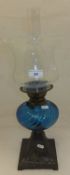 A Victorian oil lamp with a blue glass w