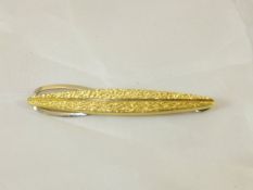 An 18 carat gold textured leaf design ti