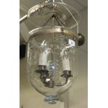 A brass three branch hall light with clear glass shade with frosted berry on branch decoration,