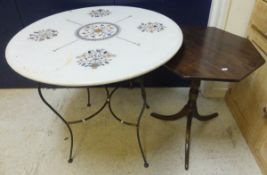 A marble topped garden table decorated w
