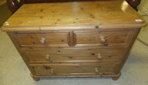 A modern pine chest of two short and two