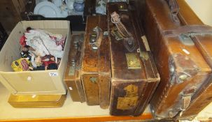 Four various vintage leather suitcases,