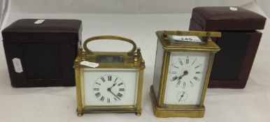 Two brass carriage clocks in leather cas