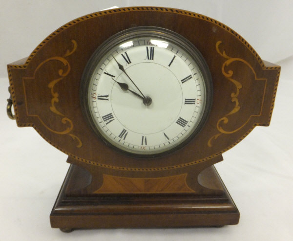 An oak cased Napoleon hat shaped mantel