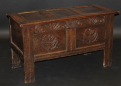 A 17th Century oak coffer, the plain three panelled top with moulded stiles opening to reveal a