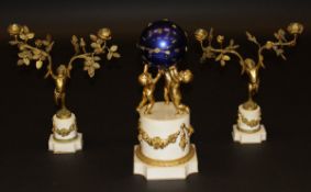 A 19th Century style marble and gilt metal clock garniture as a sphere held aloft by three putti