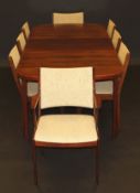 A Danish rosewood dining suite including rounded rectangular table on tapered supports, 210 cm x 110