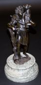 A bronze figure of a shepherd carrying k