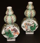 A pair of Chinese Kangxi gourd shaped vases with bamboo decorated necks and flattened panelled