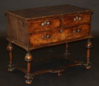 A walnut chest in the William & Mary manner, the quartered top feathered and cross banded with