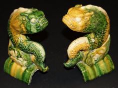 A pair of Chinese green and ochre glazed