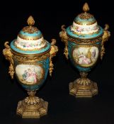 A pair of Sèvres porcelain and gilt bronze mounted urns, each decorated with figures in a garden
