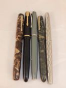 A collection of five vintage fountain pens to include a Burnham "The Nova" pen, Junior Parker