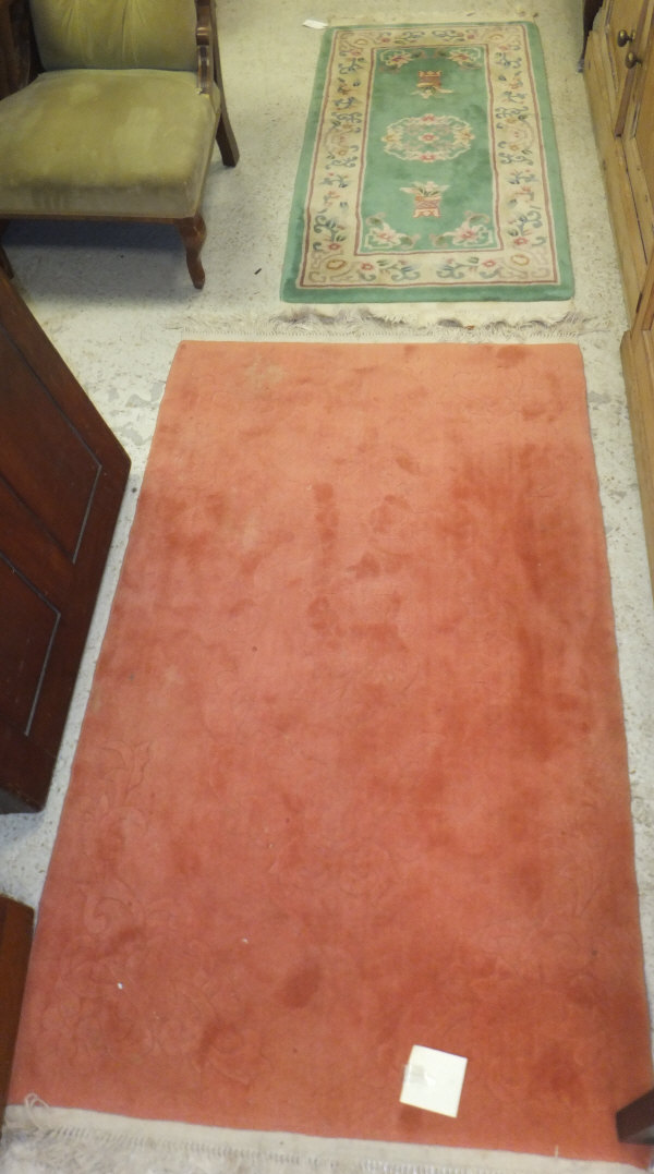 A Chinese rug in plain salmon with sculp