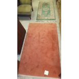 A Chinese rug in plain salmon with sculp