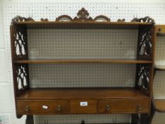 A mahogany and inlaid three tier wall shelf unit with two drawers in the Sheraton revival taste