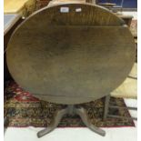 A 19th Century oak tilt top tea table on