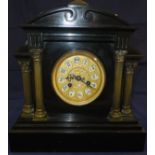 A mantel clock in polished slate, with A