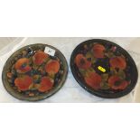 A Moorcroft pottery shallow dish decorated with pomegranate pattern on a mottled blue ground, a