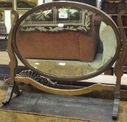 A mahogany framed oval dressing mirror