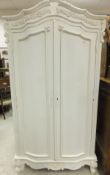 A modern white painted armoire in the Lo