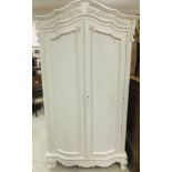 A modern white painted armoire in the Lo