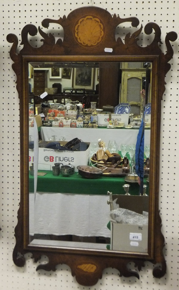 A walnut fretwork framed wall mirror in