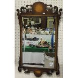 A walnut fretwork framed wall mirror in