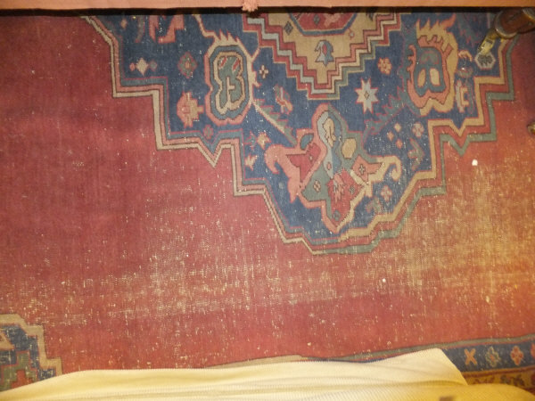 A Caucasian carpet, the central blue, red, cream and mustard medallion on a plain red ground - Image 2 of 2