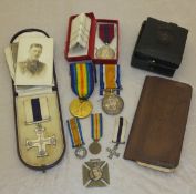 A military cross housed in leather case, together with a British War medal and Victory medal,