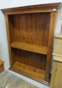 A modern stained pine adjustable bookcas