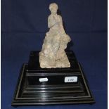 An Etruscan / Roman terracotta figure of a seated lady in Classical robes on a square plinth base,