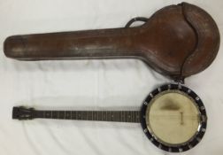 A vintage 4½ string banjo by W. Temlett London, No'd 3458, housed in an embossed leather carrying