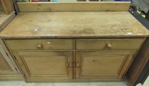 A pine dresser base with two drawers abo