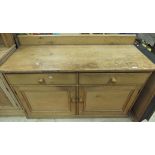 A pine dresser base with two drawers abo