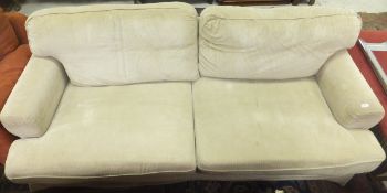A modern three seat settee with beige co