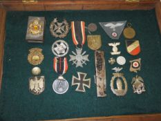 A collection of German militaria including iron cross, various other medals, cap badges, cloth
