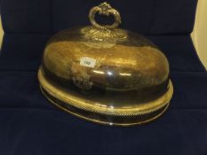 A plated meat dome with engraved armoria