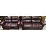 A modern burgundy leather upholstered tw