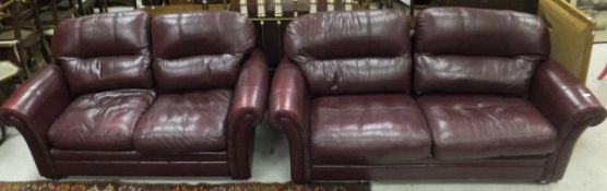 A modern burgundy leather upholstered tw
