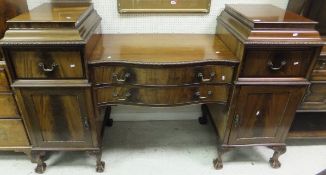 A Regency mahogany serpentine fronted pedestal sideboard with acanthus leaf carving to shoulders,