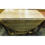 An oak oval drop leaf gate leg dining ta