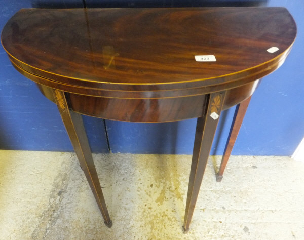 A 19th Century mahogany and inlaid demi-lune fold-over card table of small proportions, on square