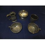 A collection of pewter ware comprising a cylindrical beaker, measure, two cups and a tobacco jar and