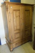 A modern Continental pine armoire with t