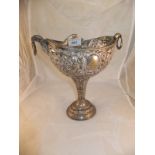 A white metal pedestal centrepiece with