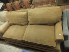 A pale gold coloured two seater sofa bed