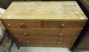 An early 20th Century oak chest of two short and two long drawers on splayed feet in the manner of