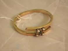 A hollow gold, seed pearl and emerald mounted bangle CONDITION REPORTS Weight approx 10.8g including